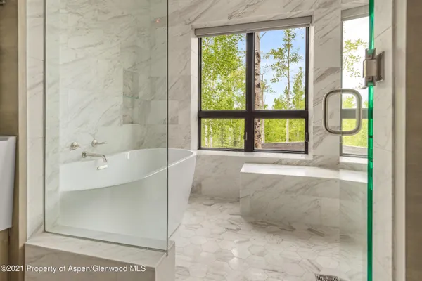 a bathroom with a bathtub and a shower
