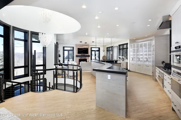 a kitchen with stainless steel appliances kitchen island granite countertop a stove and cabinets
