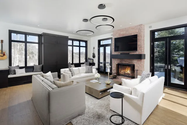a living room with furniture fireplace and flat screen tv