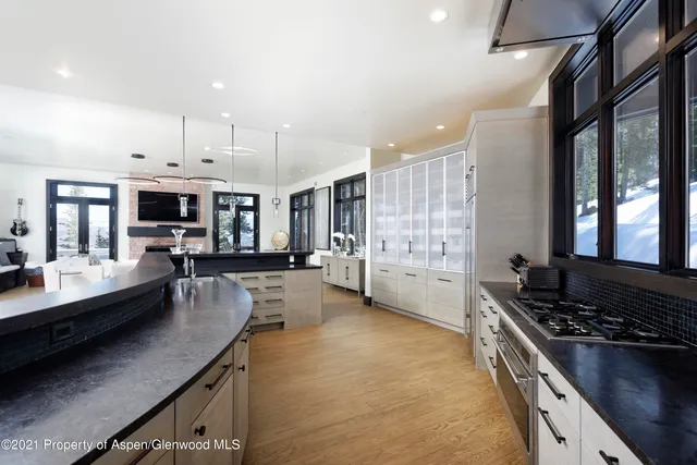 a kitchen with stainless steel appliances granite countertop a stove refrigerator and cabinets