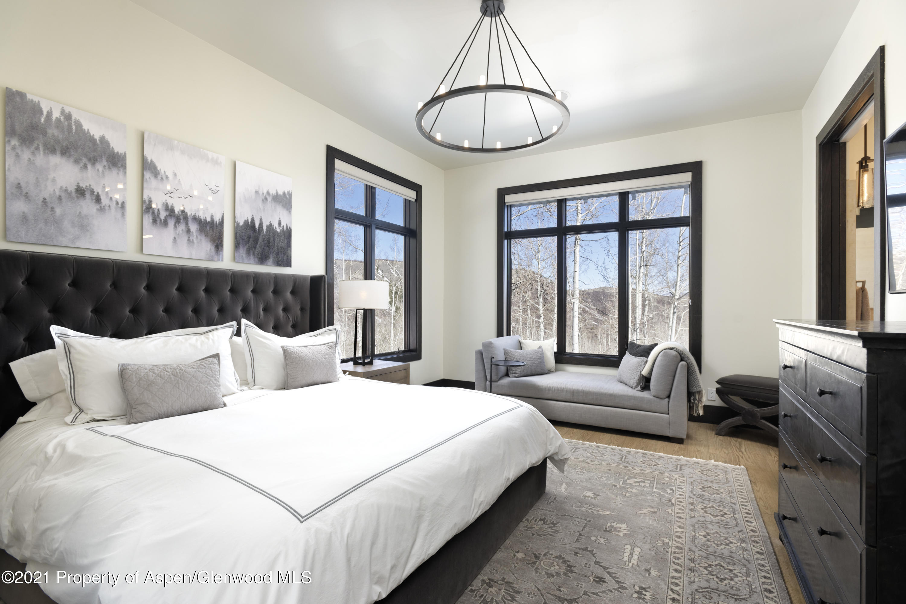 32 Elk Ridge Lane Snowmass Village, CO 81615 - Photo 10 of 34 a bedroom with a bed and a chandelier