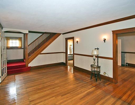 91 Valentine Road Arlington, MA 02476 - Photo 4 of 23 a view of an empty room with wooden floor and a potted plant