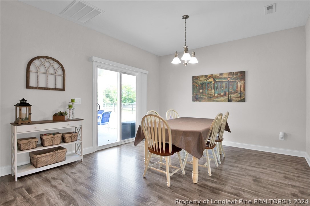 9670 East Reeves Bridge Road Linden, NC 28356 - Photo 13 of 35 a view of a dining room with furniture window and wooden floor