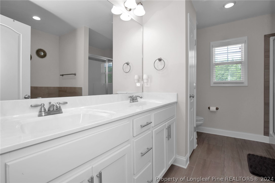 9670 East Reeves Bridge Road Linden, NC 28356 - Photo 20 of 35 a bathroom with a sink a vanity and a mirror