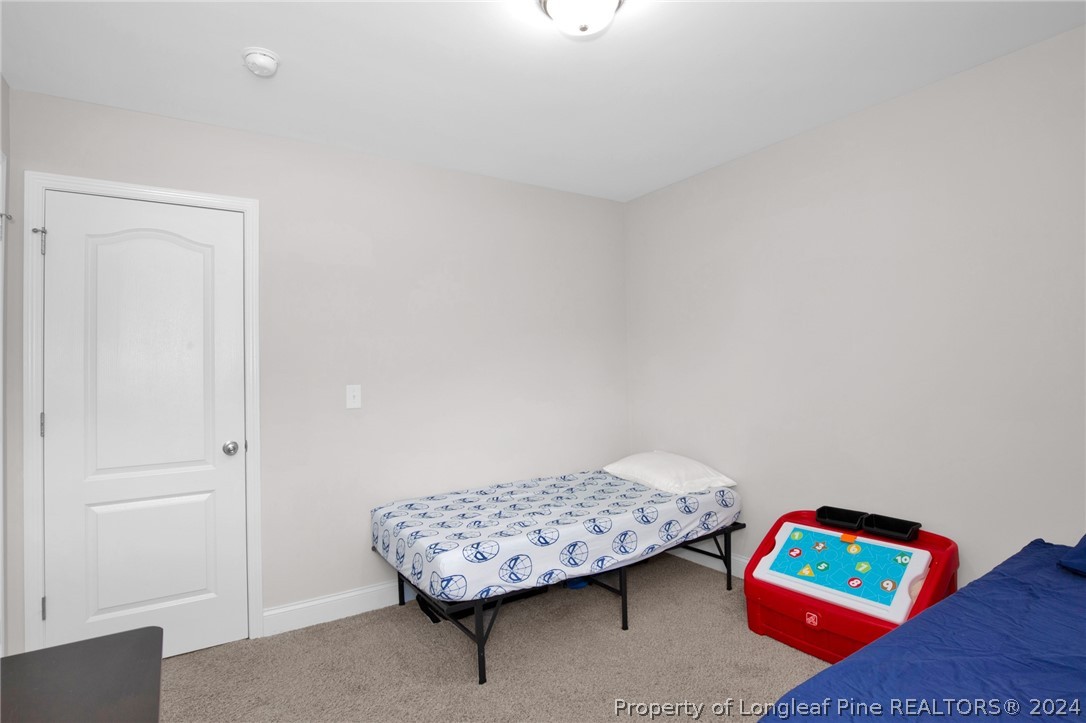 9670 East Reeves Bridge Road Linden, NC 28356 - Photo 27 of 35 a living room with a baby crib and a couch