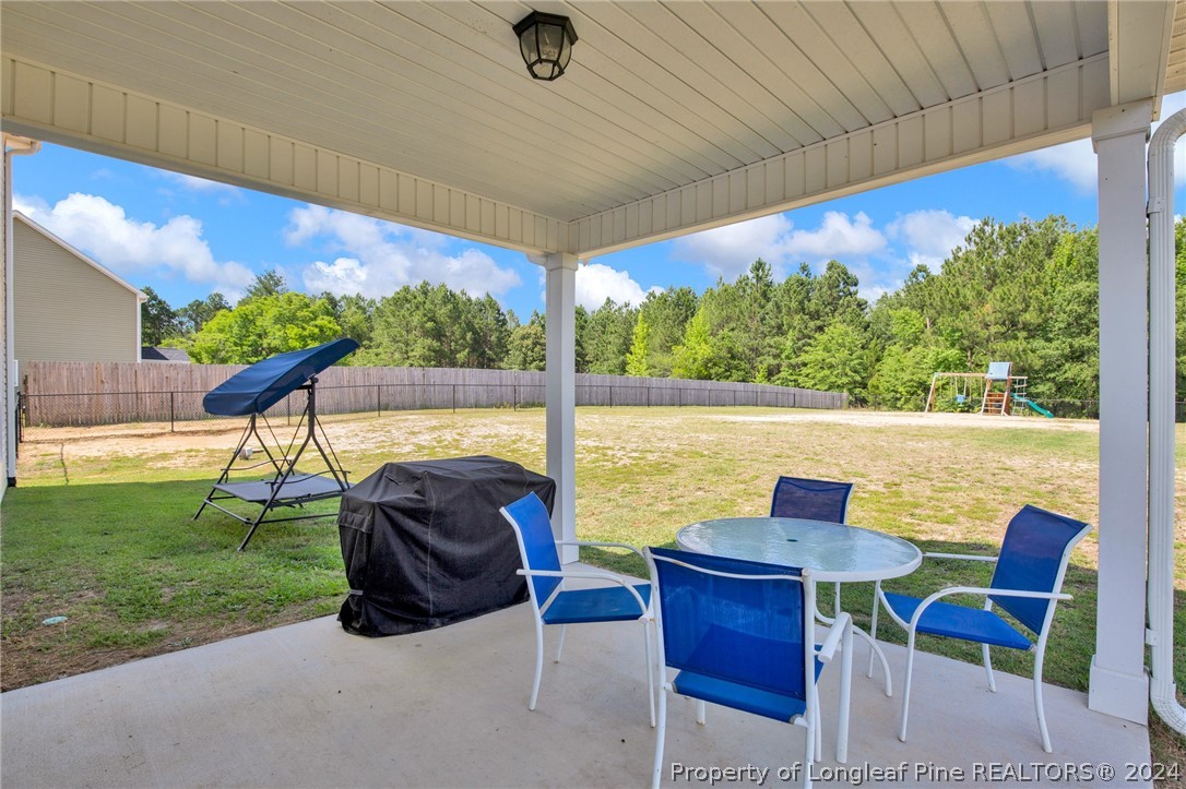 9670 East Reeves Bridge Road Linden, NC 28356 - Photo 29 of 35 a view of swimming pool with a table and chairs under an umbrella
