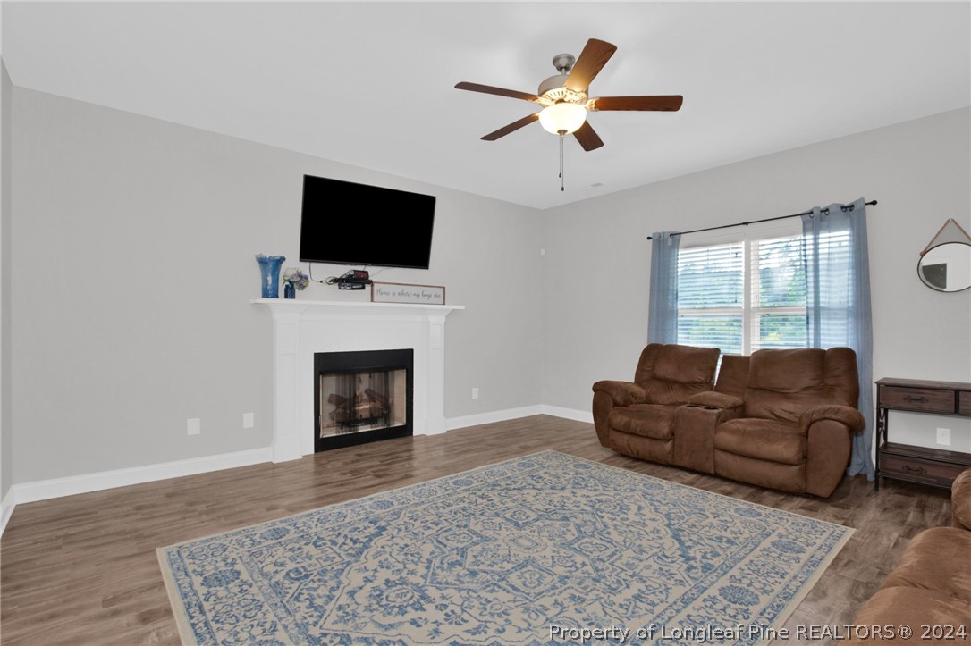 9670 East Reeves Bridge Road Linden, NC 28356 - Photo 5 of 35 a living room with furniture a flat screen tv and a fireplace