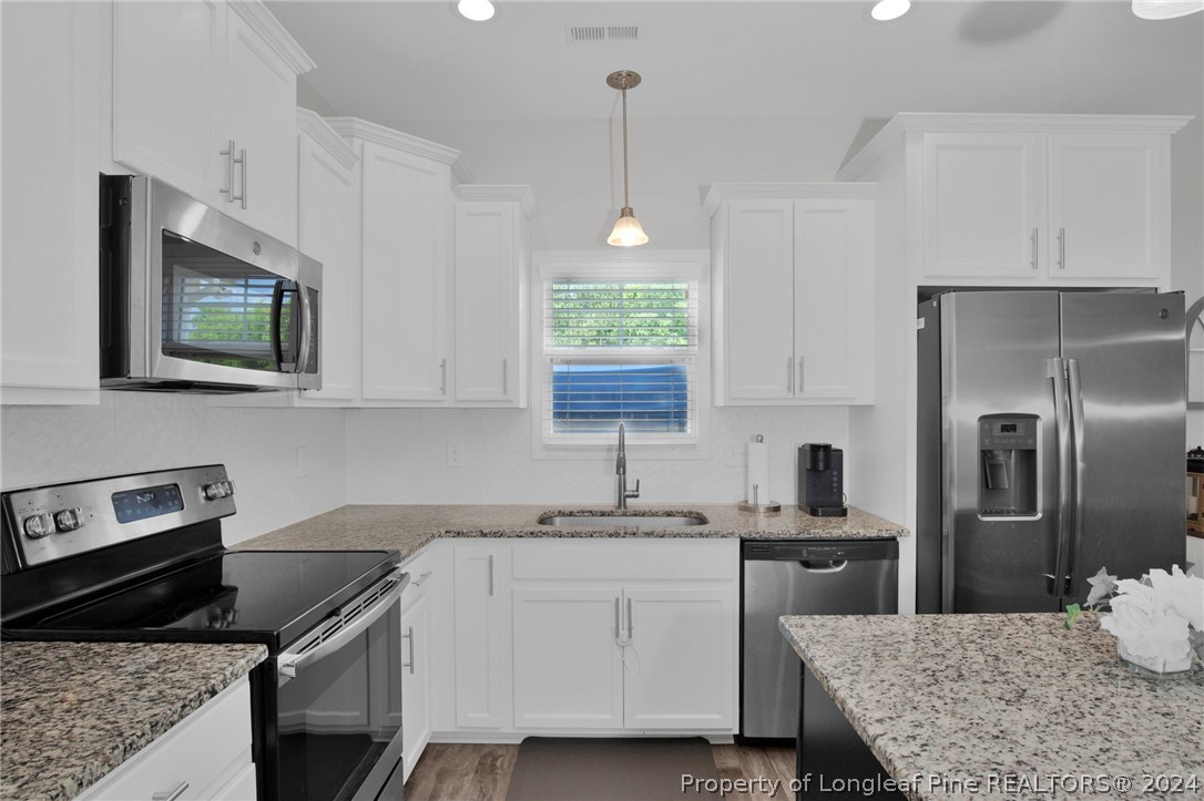 9670 East Reeves Bridge Road Linden, NC 28356 - Photo 8 of 35 a kitchen with a sink stove and refrigerator
