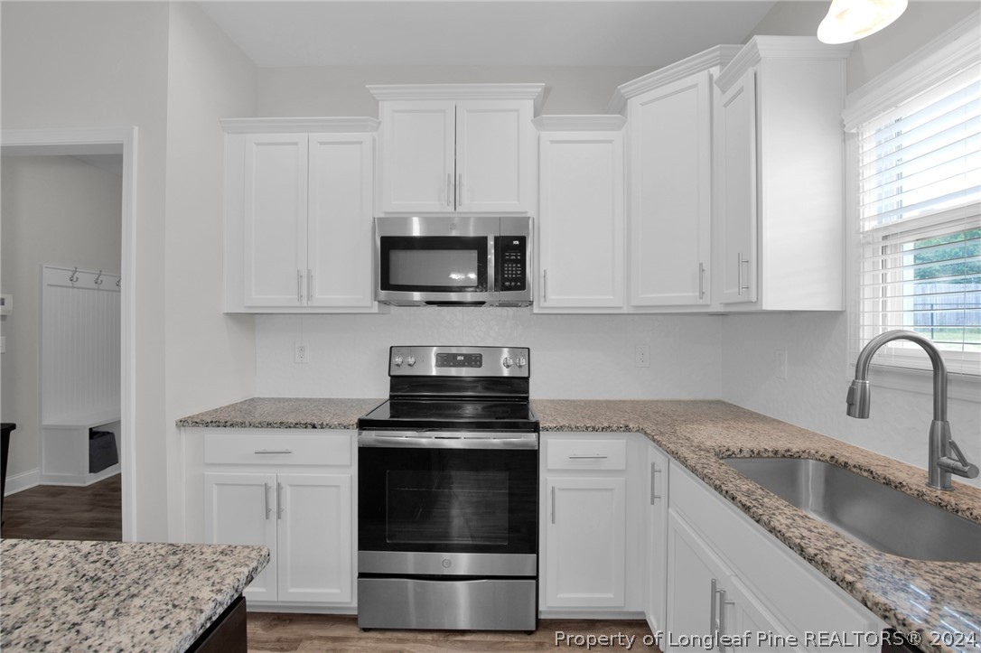 9670 East Reeves Bridge Road Linden, NC 28356 - Photo 9 of 35 a kitchen with appliances a sink and a stove