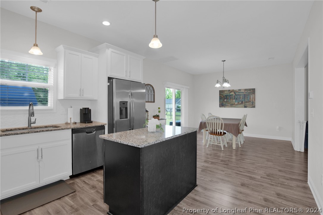 9670 East Reeves Bridge Road Linden, NC 28356 - Photo 10 of 35 a kitchen with kitchen island a sink stove and refrigerator