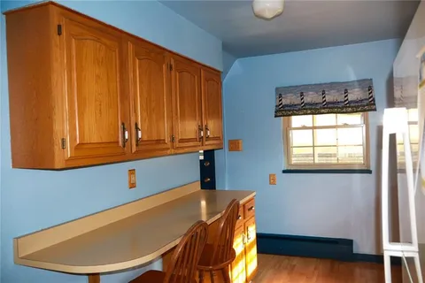 a view of a room with wooden floor and windows