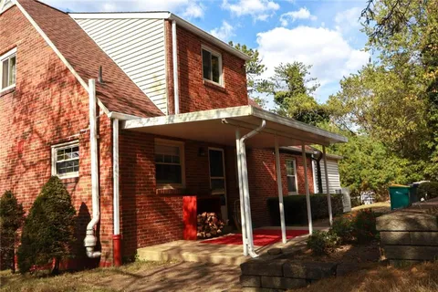 a view of a brick house with large windows