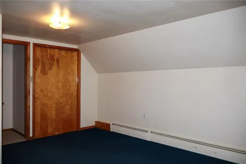 an empty room with a wooden floor and a window