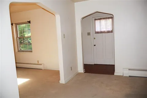 an empty room with windows and closet