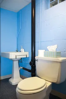 a bathroom with a sink a toilet and a mirror