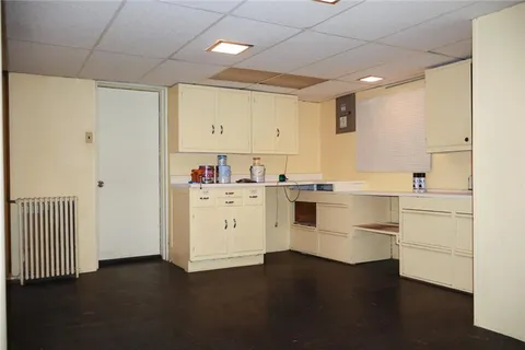 a kitchen with white cabinets and white appliances