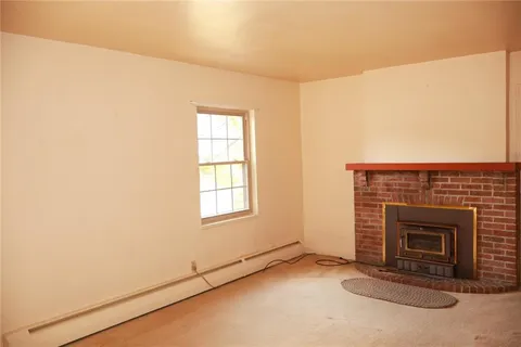 a view of an empty room with a fireplace