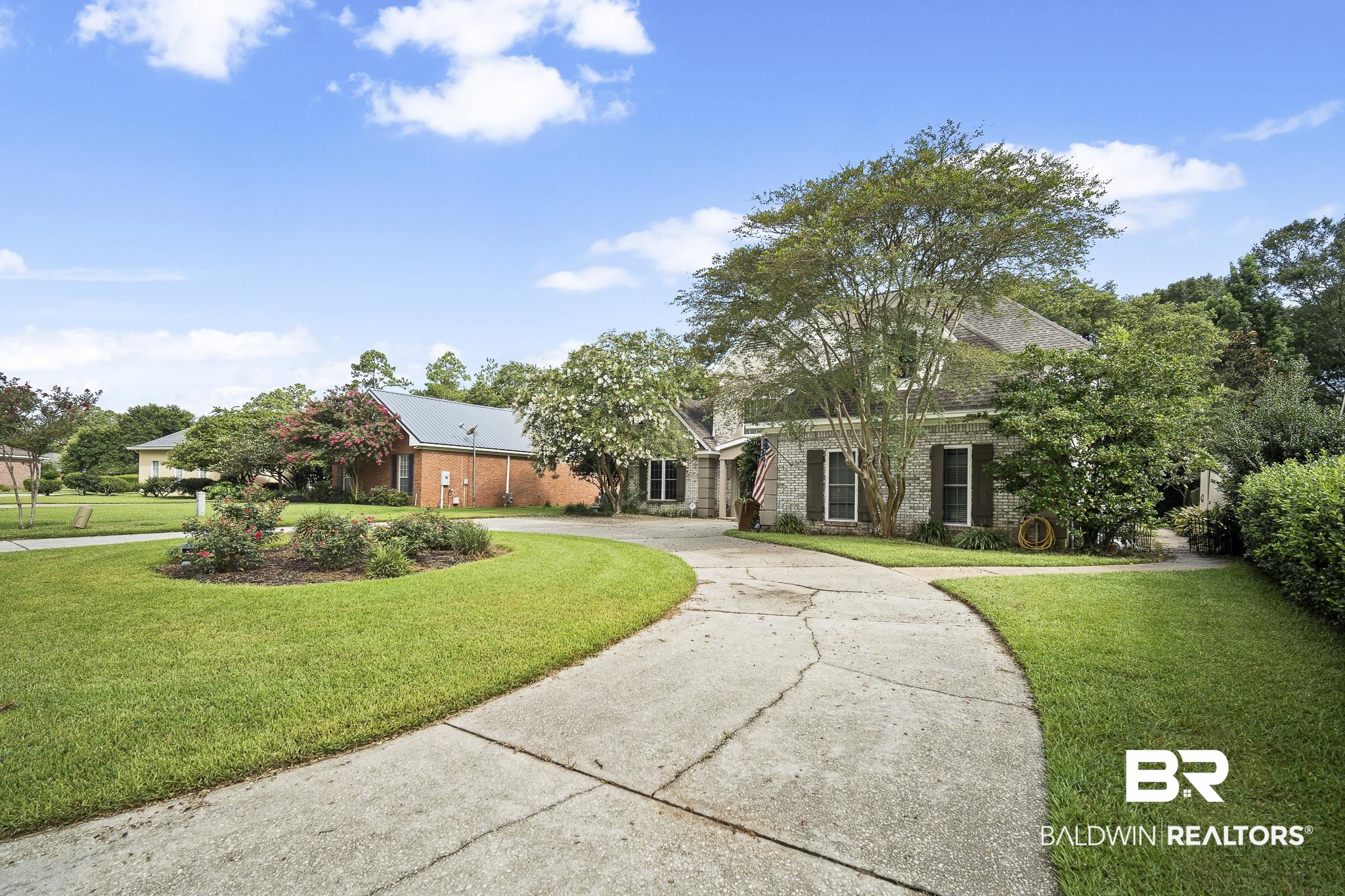 19876 Hunters Loop Fairhope, AL 36532 - Photo 34 of 40 View of front of home featuring curved driveway, a front lawn, and brick siding