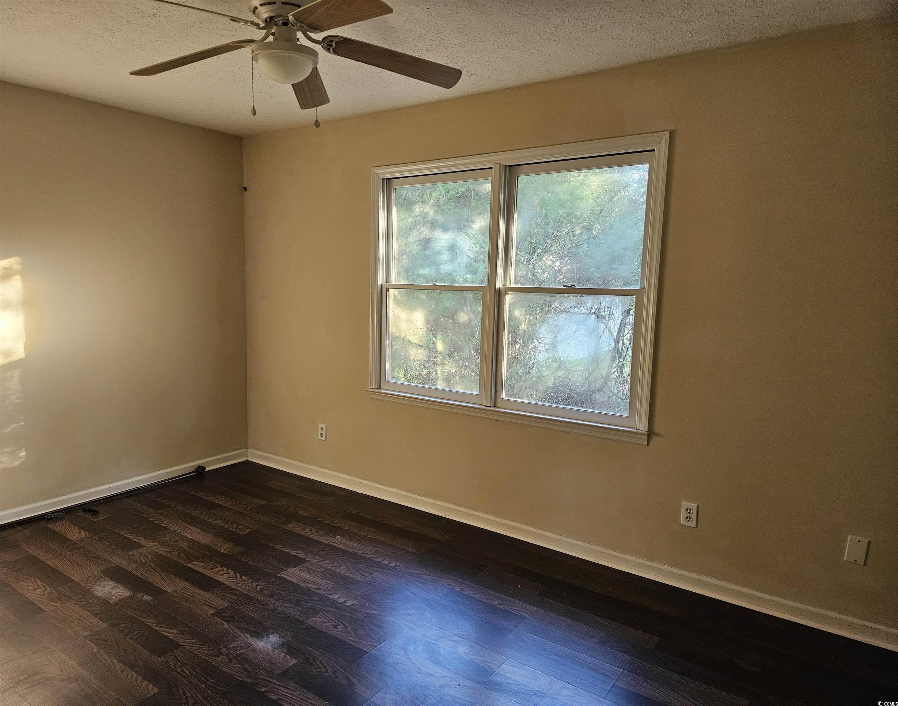602 Jefferson Way Conway, SC 29526 - Photo 14 of 20 Bedroom featuring a textured ceiling, dark wood-style flooring, and a ceiling fan
