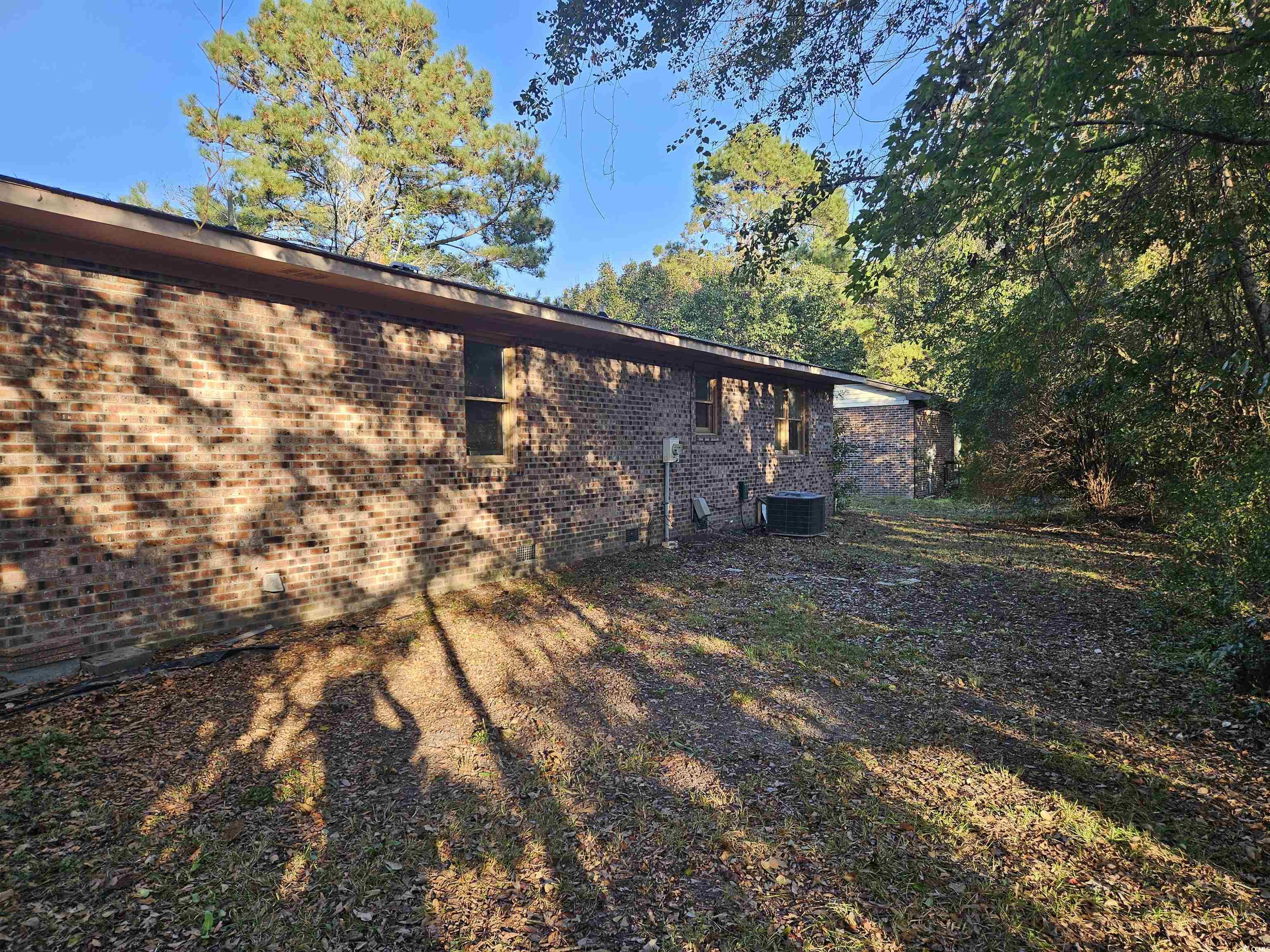 602 Jefferson Way Conway, SC 29526 - Photo 18 of 20 View of back of home with brick siding and a central air condition unit