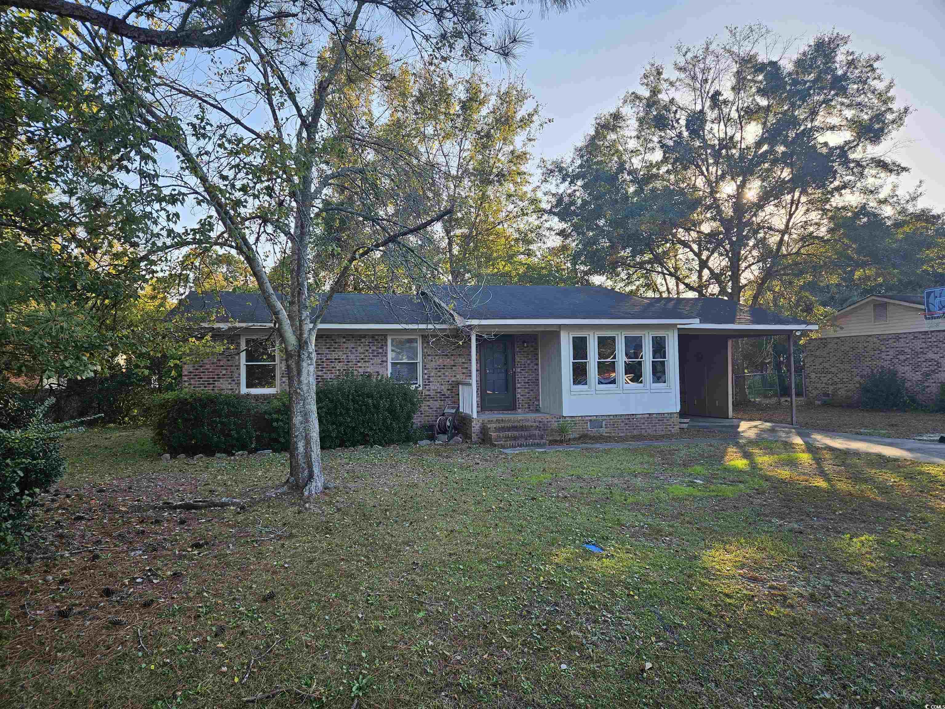 602 Jefferson Way Conway, SC 29526 - Photo 19 of 20 Ranch-style house featuring a carport, brick siding, a front lawn, and a porch