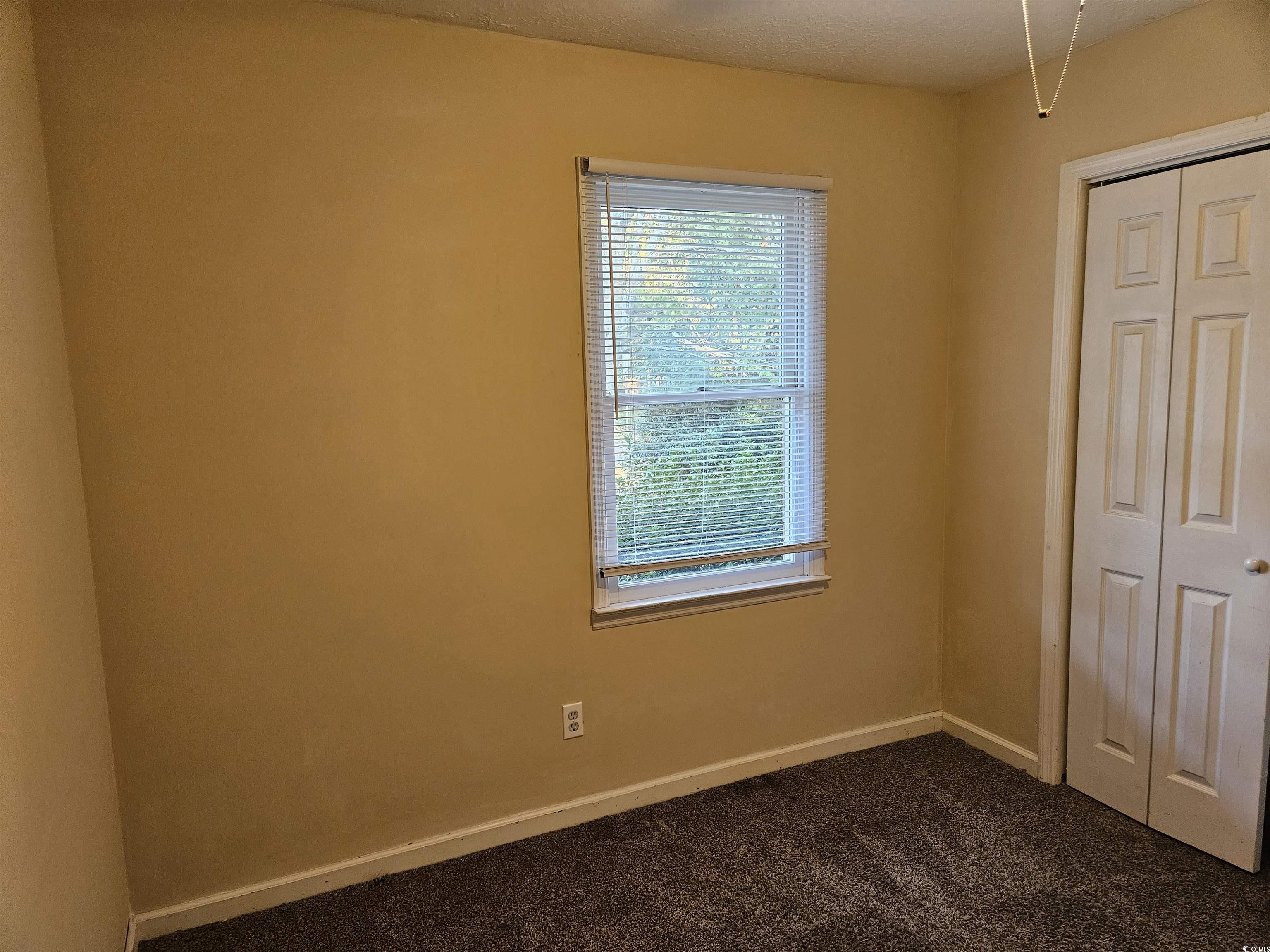 602 Jefferson Way Conway, SC 29526 - Photo 8 of 20 Unfurnished bedroom with dark carpet, a closet, and a textured ceiling