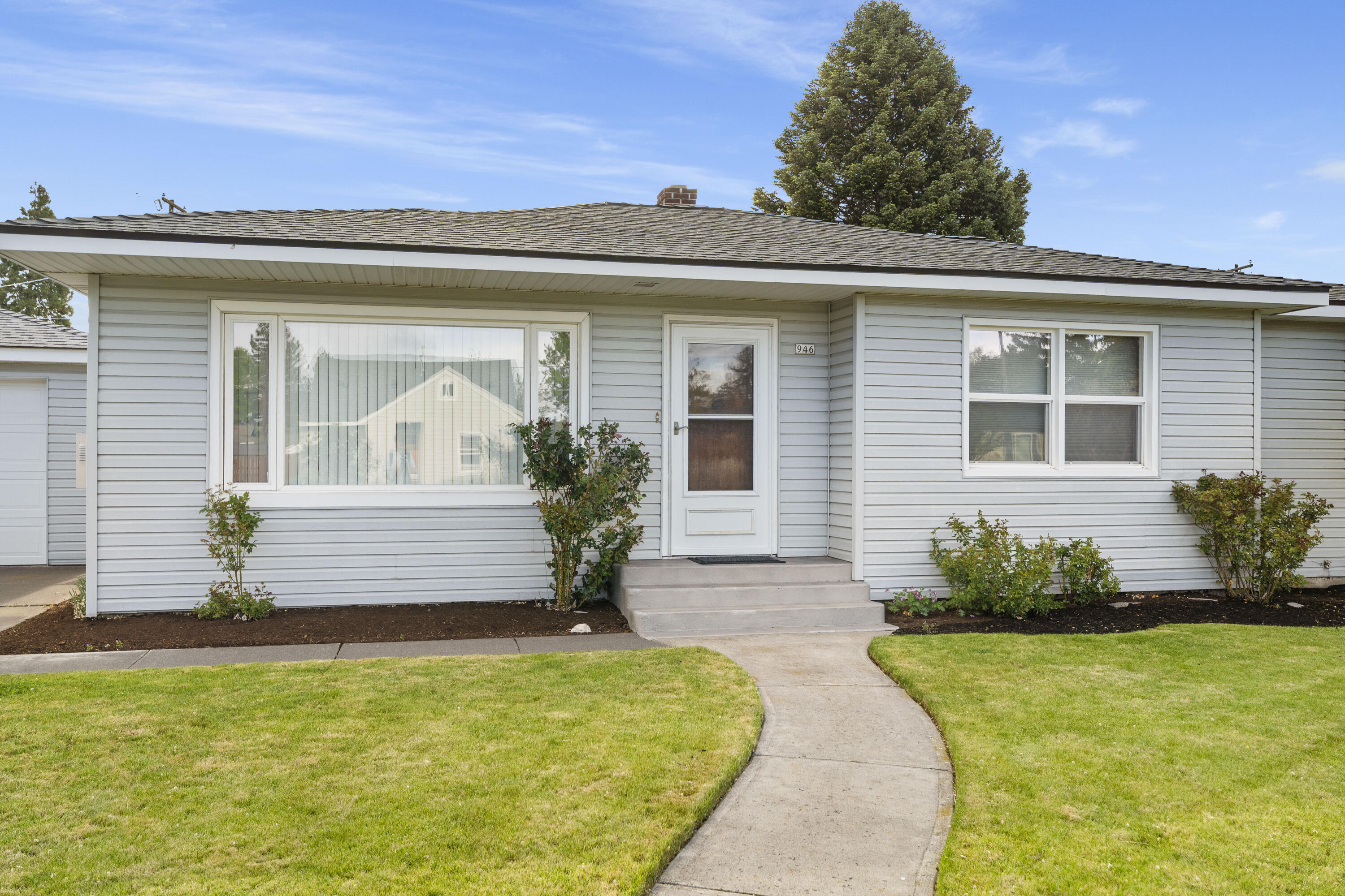 946 Southwest 13th Street Redmond, OR 97756 - Photo 3 of 49 a front view of a house with a garden