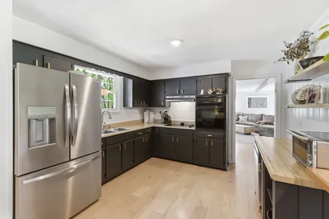 a kitchen with stainless steel appliances granite countertop a refrigerator stove and oven