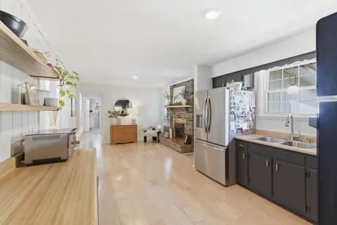 a kitchen with stainless steel appliances granite countertop a refrigerator and a sink