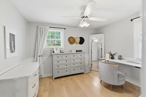 a room with a window and a dresser