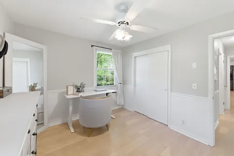 a bedroom with a bed table and a window