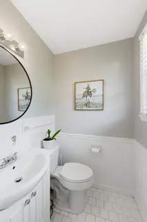 a bathroom with a tub sink toilet and mirror