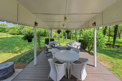 a view of a patio with a table chairs and a backyard