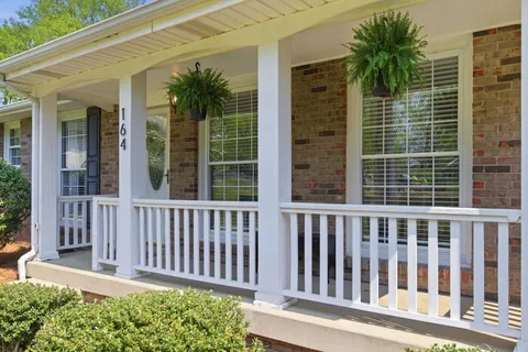 a view of a brick house with a small yard