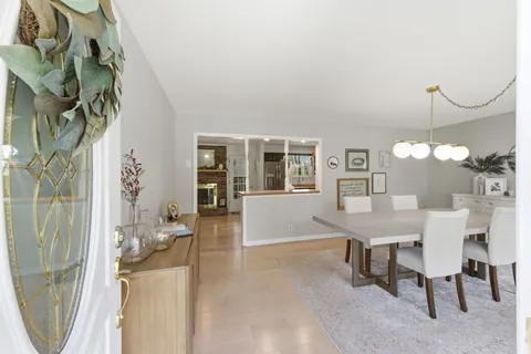 a view of a dining room with furniture and chandelier