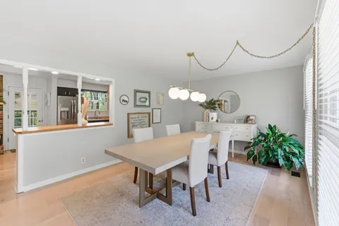 a view of a dining room with furniture and a chandelier