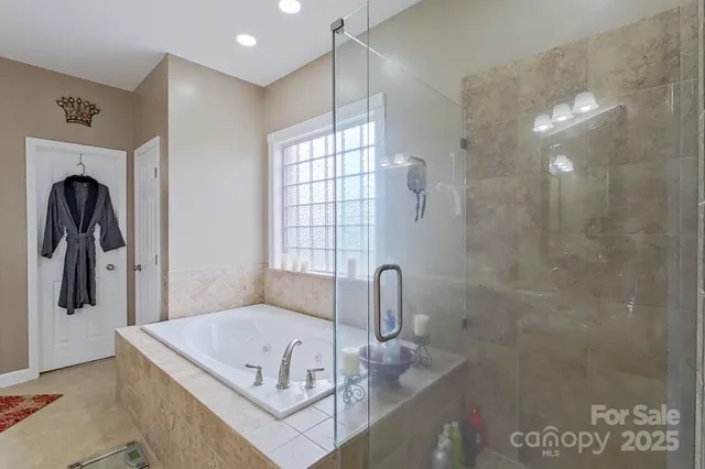 a bathroom with a tub a sink and mirror