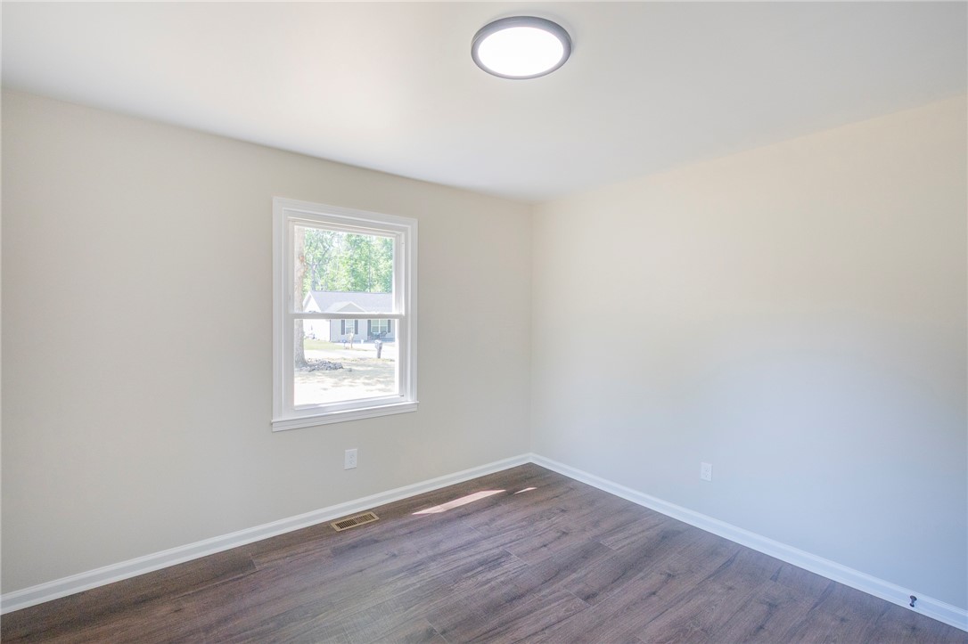 113 Linda Lane Honea Path, SC 29654 - Photo 27 of 36 This spacious room features durable wood flooring and ample natural light from a well-placed window.