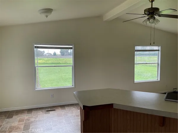 a room with a window and a ceiling fan