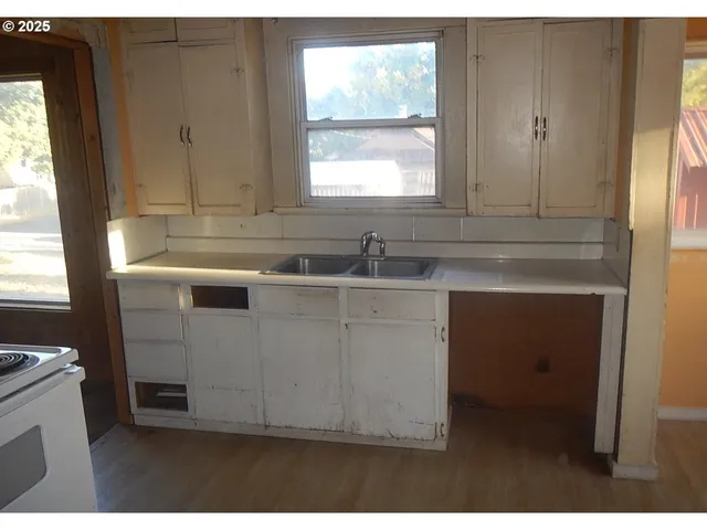 a kitchen with a sink cabinets and window