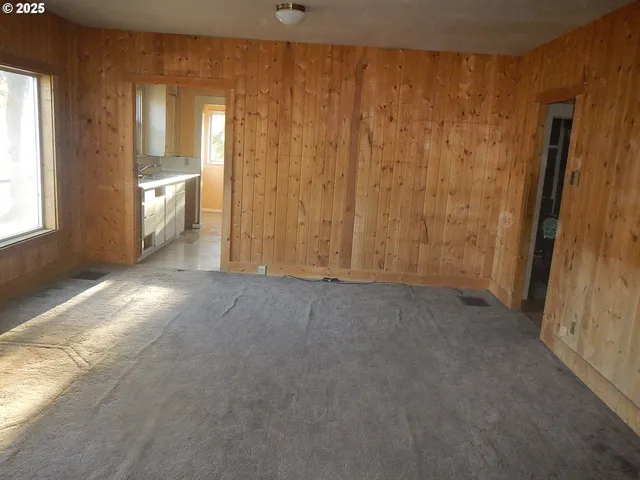 a view of an empty room and a window