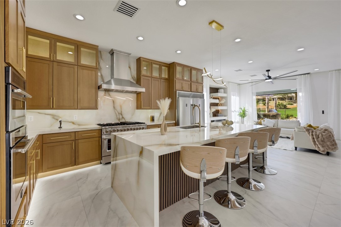5015 Rivedro Street Las Vegas, NV 89135 - Photo 3 of 91 Culinary delights await in this sleek kitchen, opening to a comfortable living area.