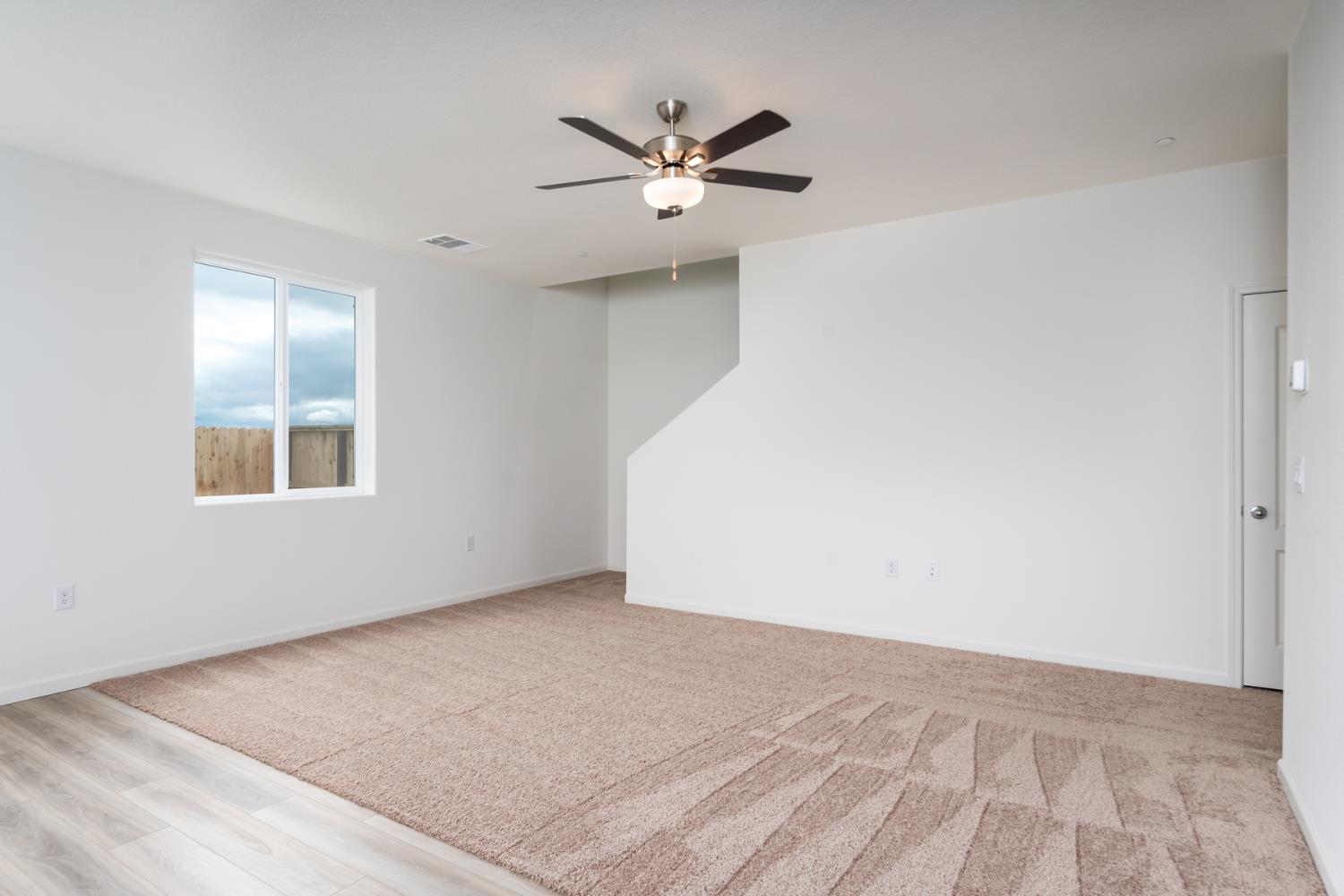 2259 Travis Court Newman, CA 95360 - Photo 6 of 17 wooden floor in an empty room with a window