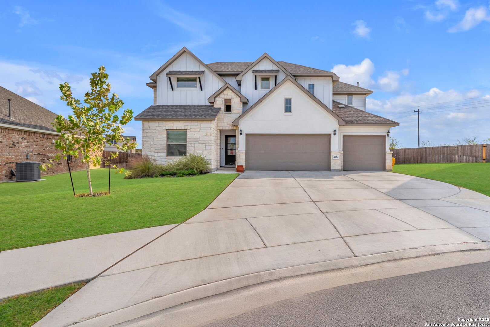 a front view of a house with a yard and trees