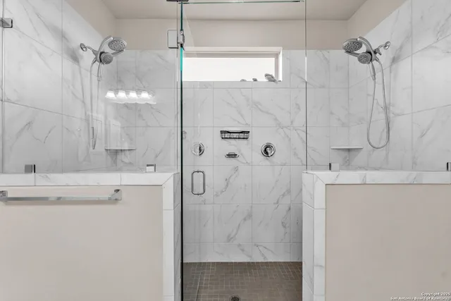 a bathroom with a shower and a sink