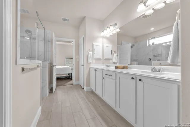 a bathroom with a double vanity sink mirror and toilet