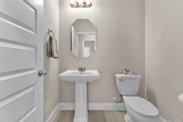 a white toilet sitting next to a bathroom sink