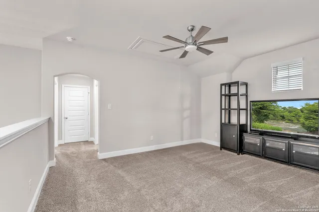 a view of a livingroom with a ceiling fan and window