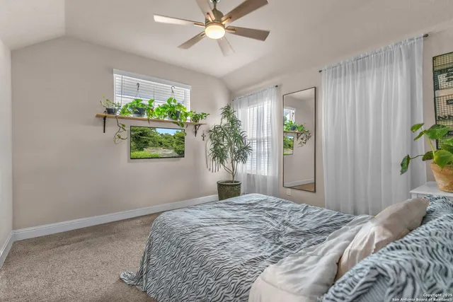 a bedroom with a bed and a potted plant