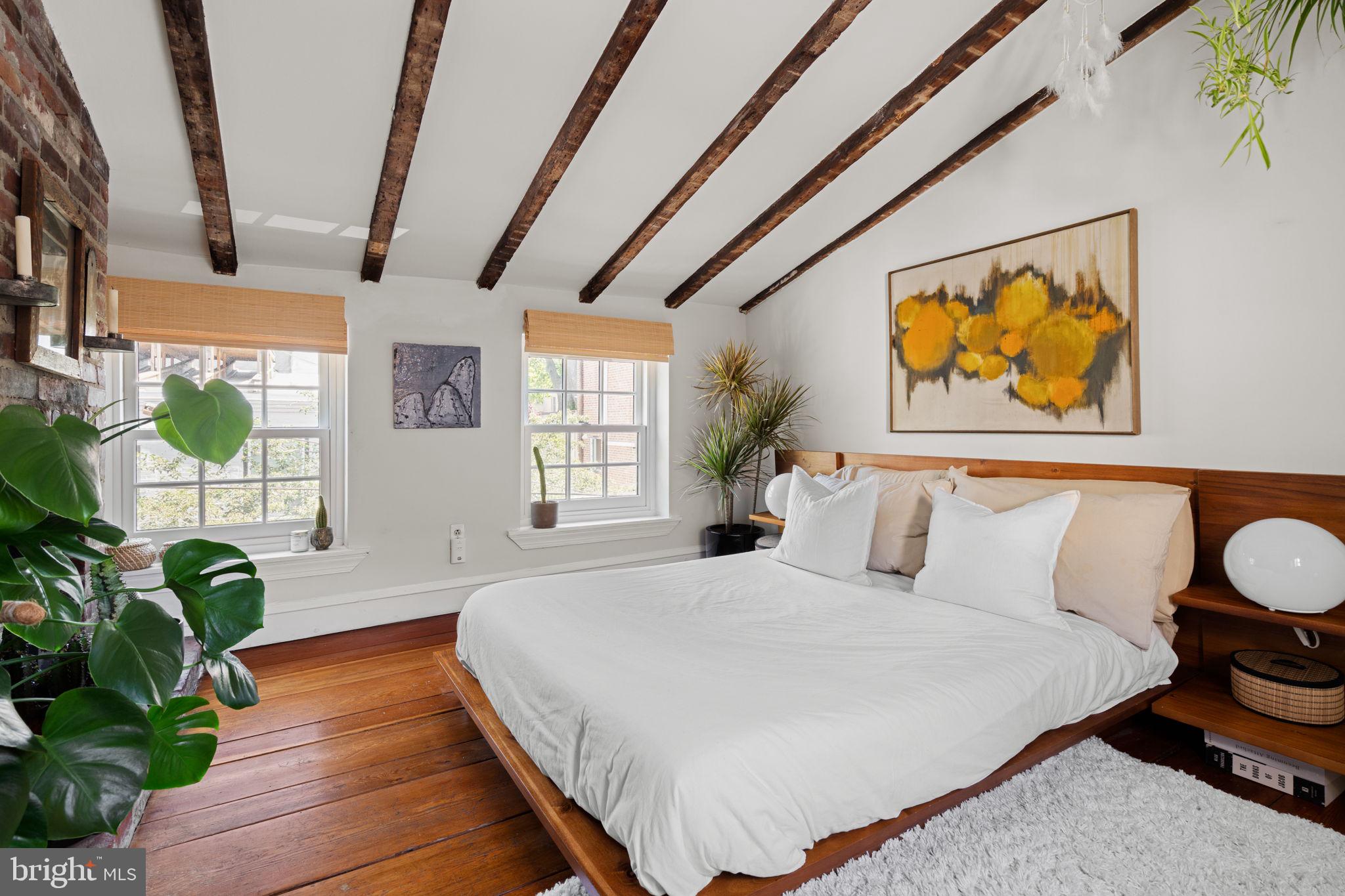 142 Carpenter Street Philadelphia, PA 19147 - Photo 39 of 49 a spacious bedroom with a bed and a window
